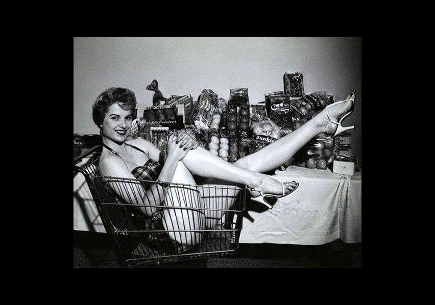 Woman in grocery store shopping cart
