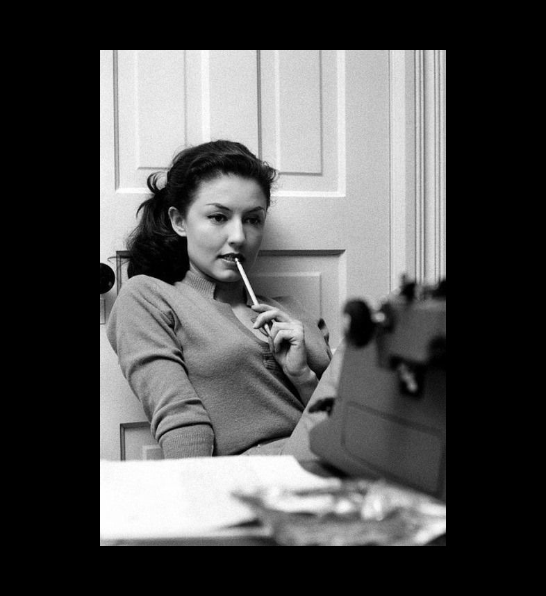 Woman thinking at typewriter